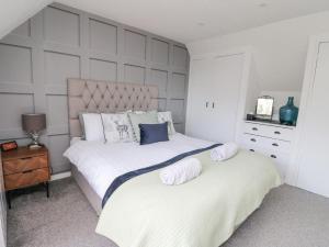 a bedroom with two beds with white sheets and blue pillows at Ben View in Arrochar