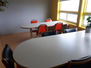 a group of tables and chairs in a room at Auberge Soleil de Mer in Bonaventure