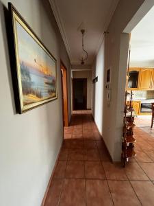 a hallway in a house with a painting on the wall at Cozy Apartment Katerini in Katerini