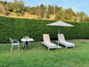 two chairs and a table with an umbrella and a table with a table at Golden days in Afantou