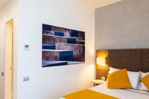 a bedroom with a bed and a painting on the wall at Hotel Como in Como