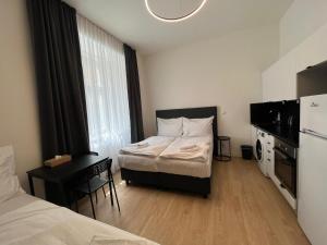 Posteľ alebo postele v izbe v ubytovaní Figaro Suites