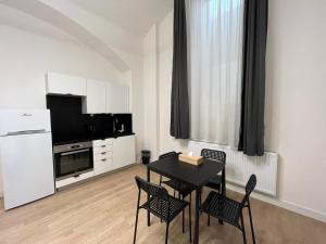 a living room with a table and chairs and a television at Figaro Suites in Prague