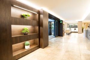 an office lobby with wooden walls and potted plants at Hotel Como in Como