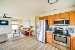 a kitchen with stainless steel appliances and a living room at Nags Head Vacation Rental with Hot Tub Near Beach! in Nags Head