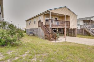 a house with stairs leading to the front of it at Nags Head Vacation Rental with Hot Tub Near Beach! in Nags Head