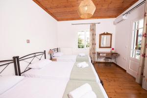 a group of four beds in a room at Perispit in Lefkada