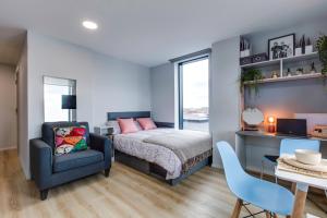 a bedroom with a bed and a chair and a desk at Yugo Explore - Kavanagh Court in Dublin