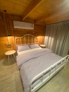 a large bed in a room with wooden walls at كوخ السحاب in Al Hada