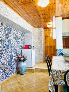 a dining room with a table and a refrigerator at Casa Colomba in Anacapri