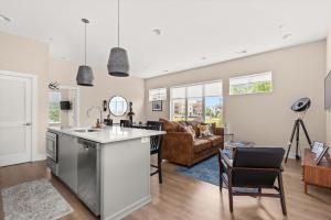 an open kitchen and living room with a couch at Mason Lofts at West End in Nashville