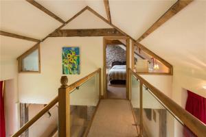 a hallway with a staircase in a house at Baddegai Holiday Cottage in Brecon