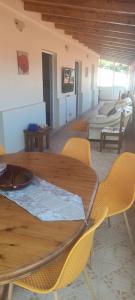 a wooden table and chairs in a living room at The Hill View House in Funchal