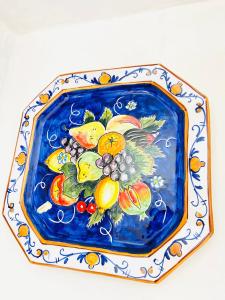 un plato azul y blanco con fruta. en Casa della Frutta en Anacapri