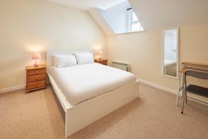 a bedroom with a white bed and a window at Host & Stay - Scotsgate House in Berwick-Upon-Tweed