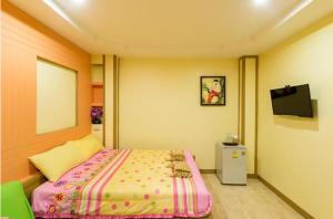 a bedroom with a bed and a flat screen tv at BaanRabiangnam kohlarn in Ko Larn +76 photos