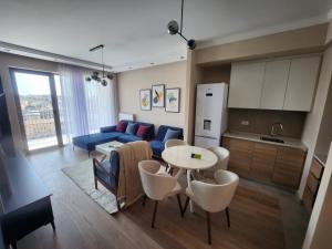 a living room with a blue couch and a table at BW VERDE LUX in Sajmište