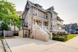 a large house with a staircase in front of it at Modern Ocean City Getaway Walk to Boardwalk! in Ocean City