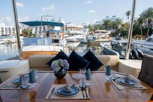 a dining table on a boat in a marina at Holiday yacht in Dubai in Dubai