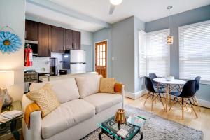 a living room with a white couch and a table at Charming Ocean City Apartment Less Than 1 Mi to Boardwalk! in Ocean City