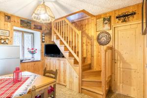 a kitchen with a wooden staircase in a house at Baita Bocheto in Levico Terme