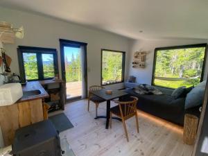 a living room with a couch and a table at Forest cabin with stunning mountain view & Sauna in Torsby