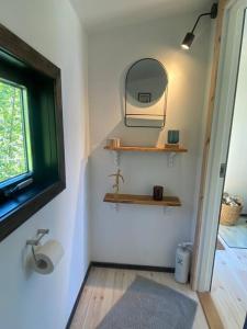 a bathroom with a sink and a mirror on the wall at Forest cabin with stunning mountain view & Sauna in Torsby