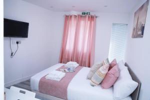 a small bedroom with a bed and a television at Impeccable 1-Bed Apartment in Harrow in Harrow