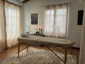 a hospital bed in a room with curtains at LOGIS Hôtel St Sylvestre in Aldudes