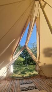 a close up of a tent with a window at Stargazer bell tent secret garden glamping 