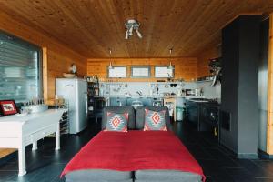 a kitchen with a red bed in the middle of a room at St. Barbara Hideaway in Škofja Loka