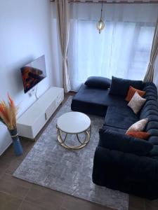 a living room with a couch and a table at Modern 1-Bedroom Unit 5 mins from CBD in Nairobi