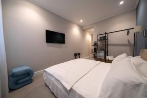 Ένα ή περισσότερα κρεβάτια σε δωμάτιο στο Porto Ercole Guest House