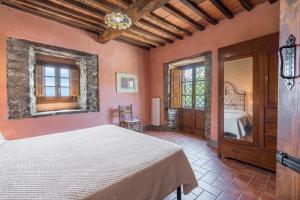 a bedroom with a bed in a room at Colle Degli Ulivi - pool, nature, relax holiday home Cortona, Italia in Cortona