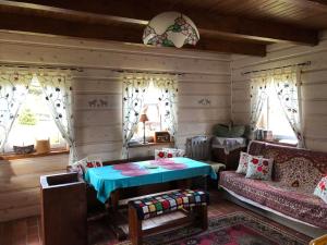 a living room with a table and a couch at Buczynowe Chaty in Wysowa-Zdrój