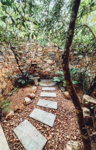 a stone pathway in front of a stone wall at Arawe Retreat in Ella