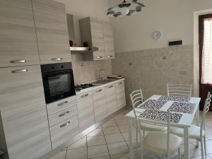 a kitchen with a table and a stove top oven at Rondi-Home in Empoli