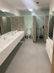 a bathroom with two sinks and two toilets at Achill Surf Centre in Mayo