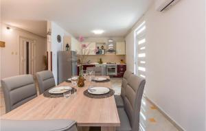 a dining room with a wooden table and chairs at Beautiful Apartment In Donje Rastane in Donje Raštane
