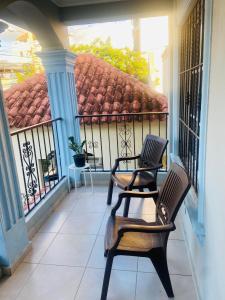 2 Stühle und ein Tisch auf dem Balkon in der Unterkunft Casa valle verde I in Santiago de los Caballeros