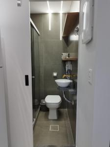 a bathroom with a toilet and a sink at C3 STUDIO in Rio de Janeiro +26 photos