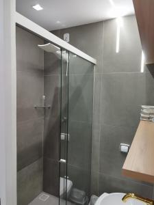 a bathroom with a glass shower with a toilet at C3 STUDIO in Rio de Janeiro