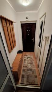 a hallway leading to a black door in a house at Apartament Rareș in Năvodari