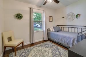 a bedroom with a bed and a chair and a window at Single-Story Webb City Home with Deck and Gas Grill! in Joplin