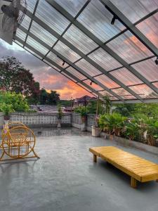 a patio with a wooden bench and a table at Eleven8 Taman Pandan in Alor Setar