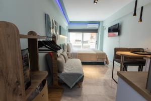 a room with a bedroom with a bed and a table at EllMar - new & modern studio in the center in Chalkida