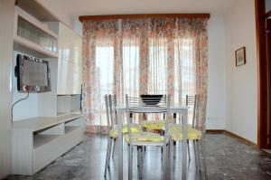 a dining room with a table and two chairs at Condominio Al Mare in Bibione