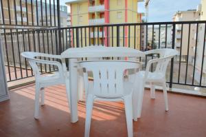 a white table and two chairs on a balcony at Condominio Al Mare in Bibione