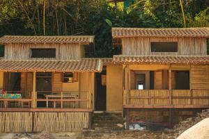 a group of houses with wooden floors at Chalé na Praia de Ponta Negra in Ponta Negra