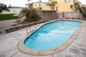 a large blue swimming pool in a yard at Sunny on the Ocean - Beachfront- Pacific Beach in San Diego